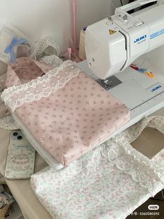 a sewing machine sitting on top of a table next to some cloths and other items