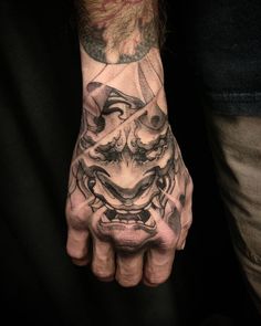 a man's hand with a tattoo on it