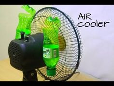 a fan that is sitting on a table with some bottles in front of it and an air cooler next to it