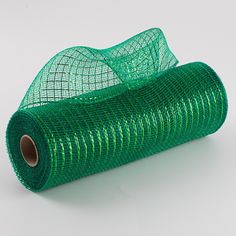 a roll of green mesh sitting on top of a white surface