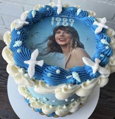 a blue and white cake with a picture of a woman on it