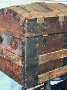 an old wooden trunk sitting on top of a table