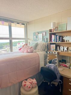 a room with a bed, desk and shelves filled with stuff on it's sides