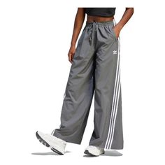 Casual Adidas Bottoms, Sporty Adidas Spring Bottoms, Sporty Adidas Bottoms For Spring, Adidas Sweatpants For Spring Streetwear, Sporty Adidas Bottoms With Relaxed Fit, Spring Athleisure Pants With Three Stripes Branding, Relaxed Fit Striped Bottoms For Spring, Adidas Sporty Relaxed Fit Pants, Gray Wide Leg Sportswear Pants