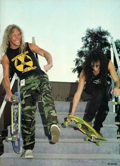 two skateboarders sitting on the steps with their boards in hand and one is holding his board