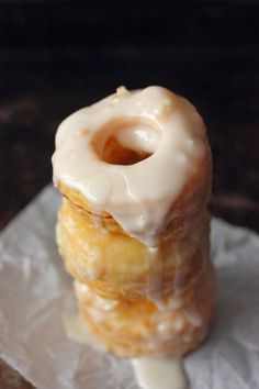 two glazed donuts stacked on top of each other with icing and oranges