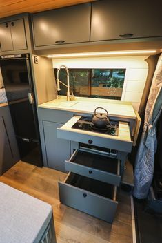 the kitchen is clean and ready for us to use in this camper's home