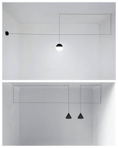 three black lights hanging from the ceiling in a white room