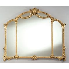 an ornate gold framed mirror against a white background