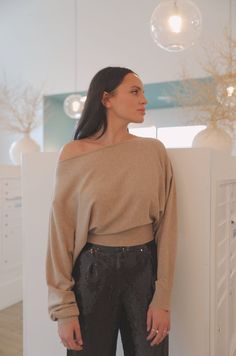 Experience luxury with this soft camel beige boat neck sweater top. It can be worn off the shoulder or pulled up to keep you comfortable while still looking sophisticated. The long sleeves give a flattering silhouette, perfect for any occasion. Pair the boatneck top with our Black Sequin Pants for an elegant dinner look. boatneck can be worn off the shoulder long sleeve model is wearing a small Beige Off-shoulder Winter Tops, Chic Oversized Boat Neck Top, Beige Off-shoulder Tops For Fall, Versatile Long Sleeve Off-shoulder Top For Fall, Chic Beige Long Sleeve Top For Fall, Chic Taupe Tops For Fall, Beige Top For Night Out In Fall, Elegant Boat Neck Tops For Fall, Chic Taupe Winter Tops