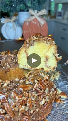 a cake with pecans on top is sitting on a glass plate