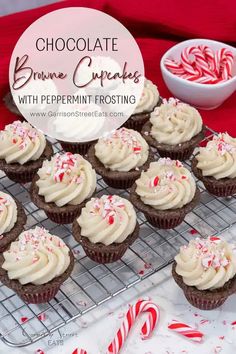 chocolate brownie cupcakes with peppermin frosting on a cooling rack and candy canes