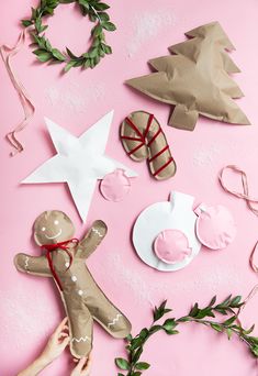 handmade christmas ornaments on pink background with wreaths and other items to make it look like they are made out of paper