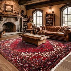 a living room filled with furniture and a large rug on top of a hard wood floor