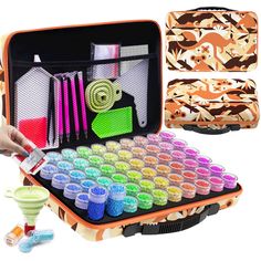 an open suitcase filled with lots of different colored paints and brushes in it's compartments