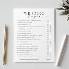 a wedding game is shown next to a pen and some paper with writing on it