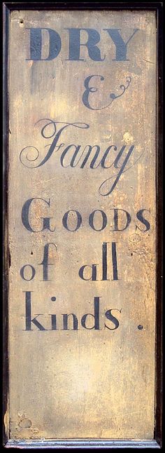 an old sign that says dry and fancy goodies of all kinds on it's side