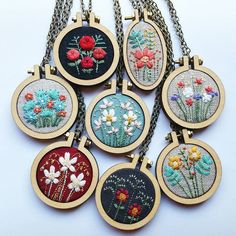 nine embroidered pendants with flowers on them