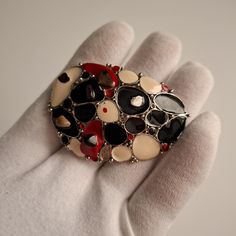 A wonderful brooch in silver and enamel tones of black, red and white colors. Several natural stones are glued into the brooch. This brooch is a handmade creation Unique Black Brooches For Gifts, Red Enamel Brooch, Red Enamel Brooch Pin, Unique Handmade Black Brooches, Red Enamel Brooch Gift, Red Enamel Brooch For Gift, Red Enamel Brooches As Gift, Red Enamel Brooches For Gift, White Colors