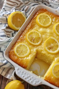 a close up of a cake in a pan with lemons