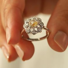 Sometimes when a girl says she likes to receive flowers as a gift, it's not the real flowers she means. Think twice and go for the safest thing - our Flora ring with Golden Rutile Ring with Moissanite. Floral jewelry is where it's at! Perfect as a graduation gift, birthday gift, anniversary ring, or a promise ring. Det Diamond White Flower Ring With Round Cut For Gift, Diamond White Round Cut Flower Ring Gift, Diamond White Flower Ring Gift, Gift Diamond White Flower Ring, Promise Flower Ring With Rose Cut Diamonds, Promise Rose Cut Diamond Flower Ring, Sterling Silver Rings With Rose Cut Diamonds For Proposal, White Gold Flower Ring With Round Cut For Gift, White Gold Round Cut Flower Ring As Gift