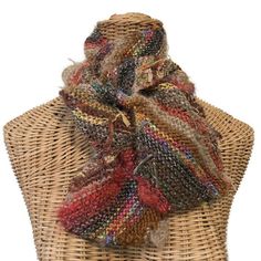 This diagonally knit woman's scarf is a boho style in a brown color way of boutique yarns. It is five inches wide and 53 inches long. Completely reversible, this scarf is hand knitted in Buttermilk Cottage's own boutique yarn, FUSION, a collection of a dozen or more different yarns, colors and textures.  When knitted it creates a unique texture and color way. Colors are predominately different shades of brown, but you will also see some teal, hot pink, orange and green.  I have also included some eyelash and metallic.  "Tails,"  where the different yarns have been added have been left for extra fun and embellishment!   Please note colors often appear different on a variety of monitors. Hand wash, cold water.  Lay flat to dry or dry clean. This item is knitted and ready to ship! Buttermilk Bohemian Alpaca Shawl One Size, Bohemian Alpaca Shawl, Multicolor Woven Scarf One Size, Multicolor Woven Scarves One Size, Bohemian Alpaca Hand Knitted Shawl, Bohemian Knitted Scarves For Fall, Bohemian Woven Winter Shawl, Bohemian Knitted Shawl For Fall, Hand Knitted Alpaca Scarves