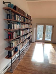 a bookshelf filled with lots of books on top of wooden shelves next to a door