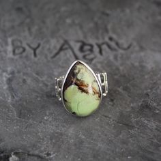 Lemon Chrysoprase Ring, Sterling Silver Ring, Lemon Chrysoprase Gemstone Jewelry For Mom, Chrysoprase Handmade Teardrop Stone Ring For Her Chrysoprase helps one to overcome compulsive or impulsive angry thoughts and behaviour, and turns your attention to positive events. Chrysoprase is a strong detoxifying stone. It is excellent for relaxation and promoting a peaceful night's sleep. This listing is for the following 1 (ONE) ring: ✦Gemstone :        Lemon Chrysoprase *may contain natural inclusions  ✦Stone Shape :    Pear Cabochon ✦Metal:                 925 Sterling Silver Dear customer you will receive the same piece or identical as shown in the picture. Since all gemstones are different from each other, I cannot guarantee the availability of the gemstone shown in the picture, but can gua Unique Green Cabochon Opal Ring, Unique Adjustable Green Opal Ring, Green Chrysoprase Cabochon Rings, Gift Ring With Large Chrysoprase Stone, Handmade Green Chrysoprase Ring, Bohemian Green Rings With Natural Stones, Bohemian Green Opal Ring, Green Bohemian Opal Ring, Unique Green Opal Gemstone Ring