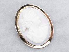 Add a touch of vintage charm to any outfit with this brooch! Featuring a gorgeous cameo design in a simple, elegant frame, this brooch is the perfect accessory for any occasion. Made with yellow gold, it's as timeless as it is stylish. Love this piece but want to make it more versatile? We here at Market Square Jewelers along with our master metalsmiths can convert this fantastic brooch into a necklace or pendant for an additional fee, please get in touch with us for more information! Metal: 10K Market Square, Cameo Jewelry, Vintage Cameo, Elegant Frame, Cameo Brooch, Vintage Brooch, Simple Elegant, Pearl Pendant, Jewelry Vintage