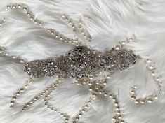 Absolutely Dazzling Finest Crystal Rhinestone & Pearl belt will take your breath away!Made with clear crystals with silver. Great to sewn onto your dress directly . Measurement :2.5 " widest point and 17" long  There is 3 yards long ribbon sash sewn underneath. Please contact us if you need to extend the crystal design .  Double face satin ribbon colors are available in White, Off White, Ivory, Silver, Royal Blue, Navy & Black.  If you want a different ribbon color, please convo me and I will source it for you.  Satin Ribbon/Sash Color - *Please specify the ribbon color of your choice during check out in the "NOTE" section. If I don't see any color name specified in the note section, Thank you for stopping by & Congratulations! :-) Elegant Silver Bedazzled Sash, Elegant Silver Bedazzled Sashes, Elegant Bedazzled Silver Sash, Elegant Bedazzled Silver Sashes, Silver Adjustable Belt With Rhinestones, Elegant Silver Embellished Bridal Belt, Silver Crystal Sashes With Rhinestones, Embellished Crystal Bridal Belt In Silver, Silver Bedazzled Bridal Belt For Wedding