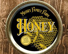 the label for a honey brand on a wooden surface with wood grain and metal frame