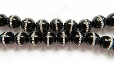 black and silver beads with crystal accents on white background, close up shot stock photo