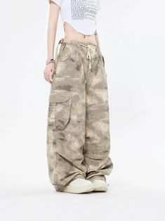 Embrace the street aesthetic with our Faded Baggy Camo Cargo Pants, perfect for making a statement while on the move.
Designed with a natural waist, these cargo pants offer a blend of comfort and durability. The camouflage pattern adds an edgy touch, while the drawstring and convenient pockets provide functionality and ease. The relaxed wide-leg silhouette ensures a nonchalant yet purposeful style, tailored for the contemporary wardrobe.
Pair them with a cropped hoodie and sneakers for running e Combat Style Baggy Cargo Jeans For Outdoor, Baggy Camouflage Utility Parachute Pants, Baggy Camouflage Cargo Jeans For Streetwear, Camouflage Cargo Jeans For Streetwear, Camouflage Wide-leg Cargo Pants For Streetwear, Urban Camouflage Parachute Pants With Pockets, High Waist Camouflage Cargo Jeans For Streetwear, Techwear Pants With Drawstring For Streetwear, Techwear Pants For Streetwear With Drawstring