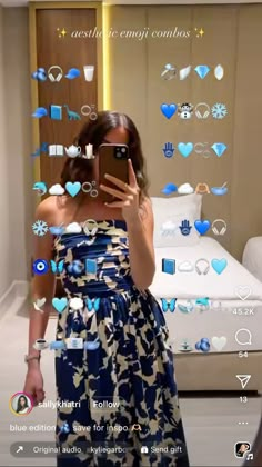 a woman taking a selfie in front of a bed with blue hearts on it