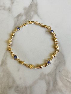 "Perfect worn on its own or layered with our other bracelets. 18k gold filled. Cubic zirconia 7\" length Ready to ship *18k gold filled is a more affordable alternative to solid gold jewelry. Gold filled is a layer of gold bonded onto a base metal with heat and pressure that contains 100+ times more gold than gold plated jewelry.  *It is very durable and tarnish resistant.  *With proper care, gold filled jewelry can last several years. Avoid contact with harsh chemicals, perfumes, water, etc.  *Gold filled jewelry can be worn by people with sensitive skin because it is hypoallergenic, lead free and nickel free." Blue And Gold Bracelets, Gold Star Bracelets For Everyday, How To Layer Bracelets, Gold And Blue Aesthetic, Gold And Blue Jewelry, Dainty Bracelet Stack, Jewelry Inspo Gold, Blue And Gold Jewelry, Blue Gold Jewelry