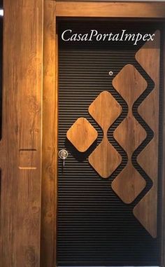 a wooden door with black and brown designs on the front, and white lettering that reads casa portalimpex