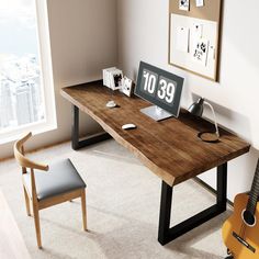 a desk with a guitar and clock on it