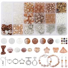 many different types of beads and accessories are arranged in a box on a white background