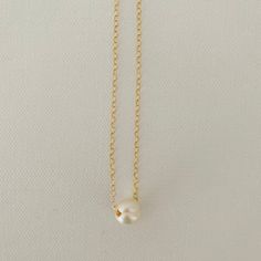 Just A Pearl! This simple yet elegant necklace is part of my Just A Pearl collection. One single pearl dangles from a delicate gold necklace. It measures 16 inches and length and can be adjusted to 15 inches for choker length. Minimalist Pearl Chain Necklace With Pearl Charm, Classic Gold Charm Necklace With Pearl Drop, Classic Gold Pearl Chain Charm Necklaces, Simple Pearl Jewelry With Delicate Chain, Classic Gold Charm Necklace With Pearl Chain, Simple Pearl Chain Necklace As Gift, Simple Pearl Necklace Gift, Simple Pearl Drop Necklace For Gifts, Simple Pearl Necklace For Gift