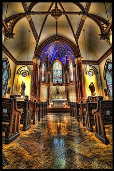 the inside of a church with stained glass windows