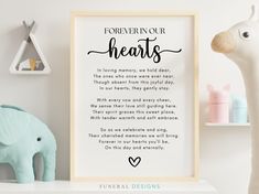 a framed print with the words forever in our hearts on it next to a toy elephant