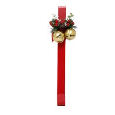 a red ribbon with two bells and holly on the top, hanging from it's side