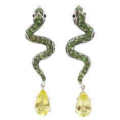 Tsavorite 6.99 carats, Cabochon Blue Sapphire 0.43 carat and Lemon Quartz 13.08 carats Earrings set in Silver Settings Width: 2.0 cm Length: 7.3 cm Total Weight: 17.59 grams *Please note that the silver setting is plated with rhodium to promote shine and help prevent oxidation. However, with the nature of silver, oxidation may occur over time and use. "We first opened doors in 1980 when it was then situated in the vicinity of the Victory Monument; a small and modest storefront with a couple of counters. From its humble beginnings to where it stands today, our company has proven its abilities as a jeweler. Since the beginning, we have been supplying fine quality pieces to dealers, wholesalers and customers worldwide. From then till now, our business still interrelates its name with quality Lemon Quartz, Quartz Earrings, Earrings Set, Blue Sapphire, Earring Set, Clothing And Accessories, Monument, Sapphire, Jewelry Earrings