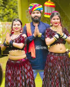 three people in colorful clothing standing next to each other