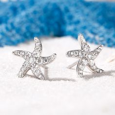 The starfish is an eternal symbol of renewal and regeneration of self. Its five limbs symbolize the five elements – earth, water, air, fire and ether – and signify perfect balance between all. The shimmering stones bring clarity to thoughts and calm the mind. Wear these starfish earrings not just to look beautiful, but also to get in touch with your intuition and feel ready to tackle whatever comes your way.Carat Weight: 1.28 ctStone Size: 1.2,0.9,2,1.5 mmStone Type: Jeulia® StoneNumber of Stone Elegant Starfish Charm Earrings As Gift, Elegant Starfish Charm Earrings For Gift, Elegant Silver Starfish Jewelry, Sterling Silver Starfish Earrings In Silver, Blue Sterling Silver Starfish Jewelry, Silver Sterling Silver Starfish Earrings, Sterling Silver Starfish Earrings, Elegant Nickel-free Starfish Jewelry, Elegant Starfish-shaped Nickel-free Jewelry