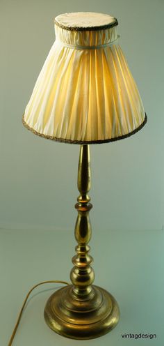 a lamp that is on top of a table with a cord attached to the base