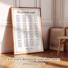 a wooden easel sitting next to a white wall with a blue and white seating chart on it