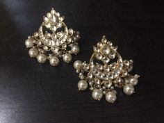 *It's Handmade Indian Ethnic Kundan Chandbali Earrings with white kundan and Pearl drop. *It's made from Silver n Copper with White Kundan Stones Settings with 22k gold Plating as shown in picture. *It it Pure Ethnic Look with Antique Touch and 1.8 inch size. *Our all jewelry is made from semiprecious stones and beads. *WARRANTY: ITS GENUINE HANDMADE JEWELRY AND WE ARE GIVING LONG LIFE WARRANTY FOR OUR ALL ITEMS. All of our Kundan Jewelry is 100% handmade with ancient Kundan stone setting method White Bridal Earrings With Intricate Design For Festivals, White Intricate Design Danglers For Festivals, Traditional White Bridal Earrings For Parties, White Intricate Danglers For Festivals, Traditional White Danglers With Intricate Design, Festive White Danglers With Intricate Design, Elegant White Earrings For Navratri, Bohemian Chandelier Earrings For Weddings And Festivals, White Bollywood Chandelier Earrings With Intricate Design