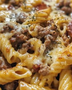 a close up view of some pasta with meat and cheese