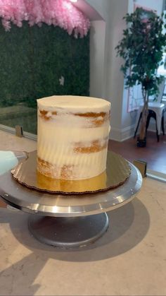 a white cake sitting on top of a metal plate